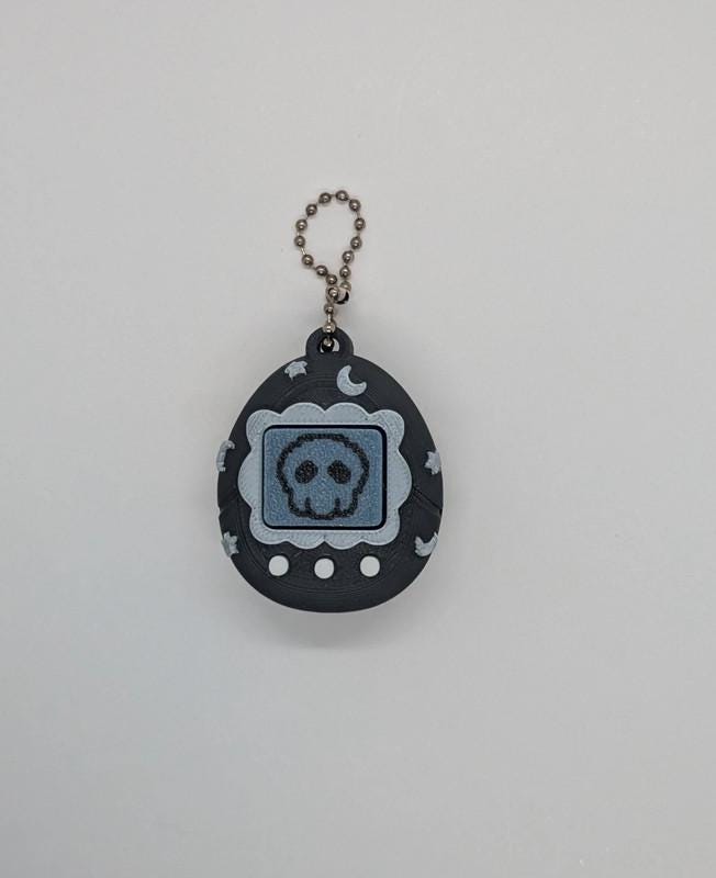 Black Tamagotchi Style Clicker Fidget with Silver Stars – Pet Face